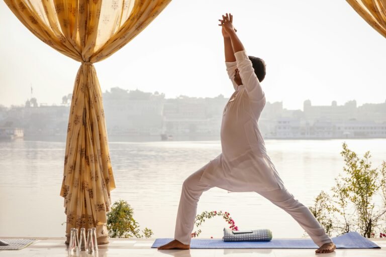 a woman practices yoga in front of a lake